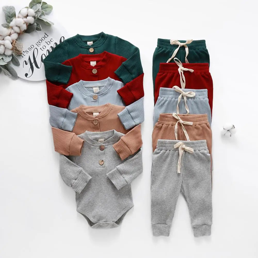 Newborn ribbed long sleeve bodysuits and elastic waist pants set in green, red, blue, caramel, and gray colors.