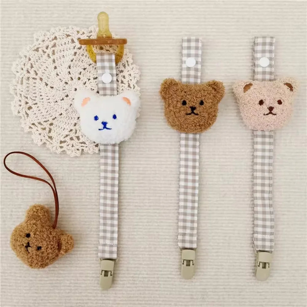 Bear Pacifier Clips in white, khaki, and light brown with gingham straps and clips for babies.