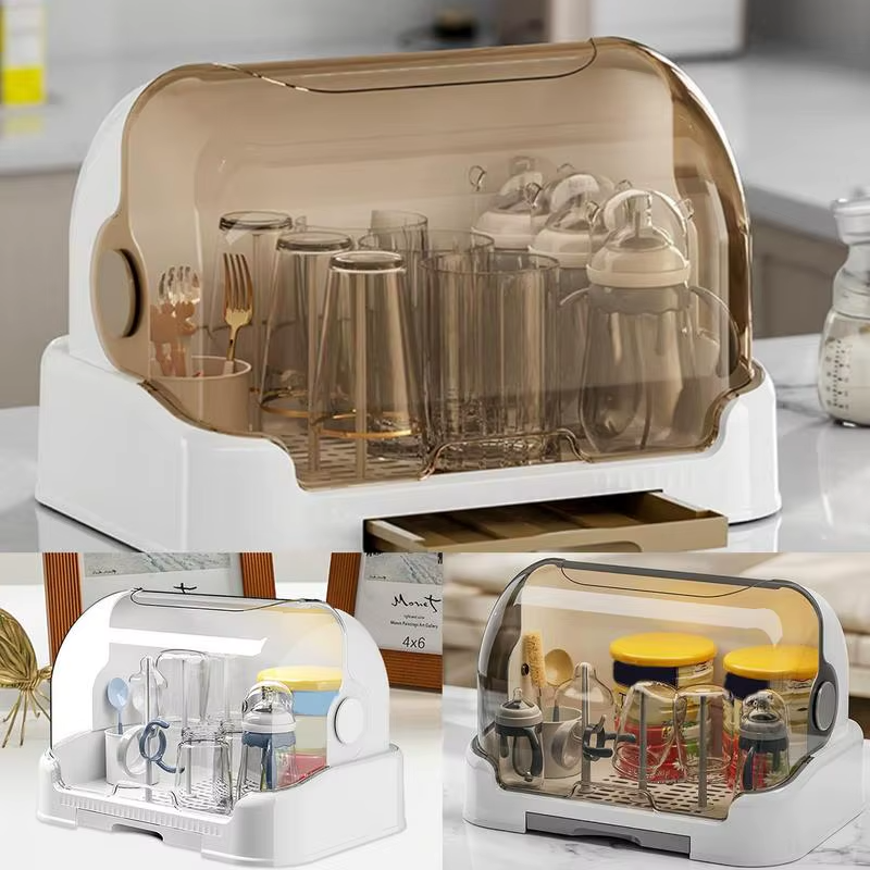 White baby bottle drying rack with brown dustproof lid holding bottles and utensils, removable drip tray visible.