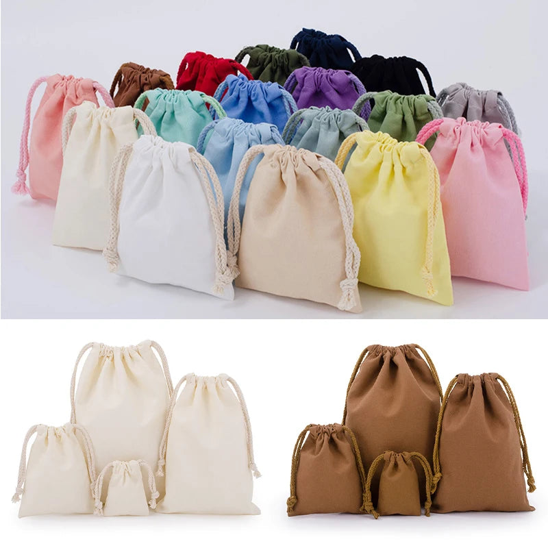 Set of reusable cotton drawstring storage bags in assorted pastel and neutral colors for organizing baby essentials.
