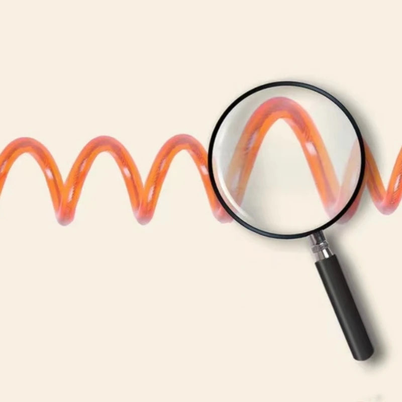 Close-up of orange coiled toddler safety leash showing coil detail under magnification.