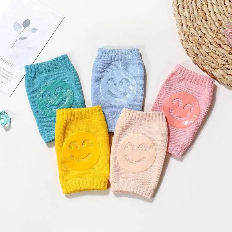 Five-color set of Comfort Crawl baby knee pads laid out side by side.