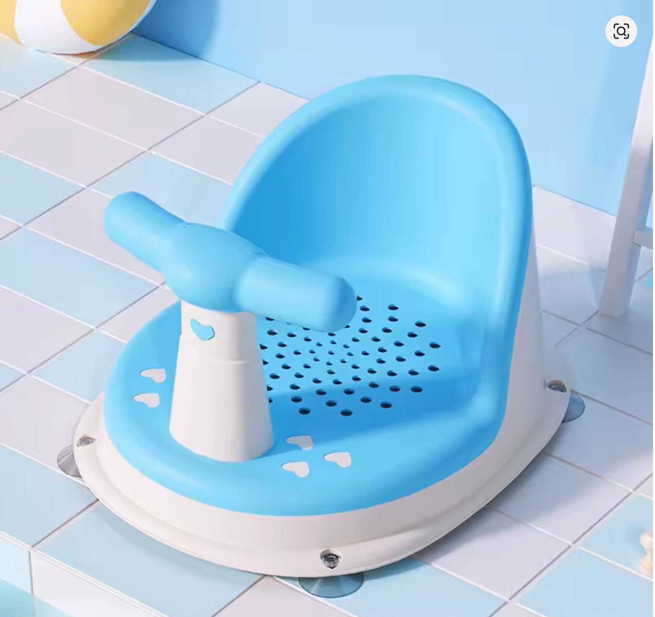 Blue Comfy Baby Bath Seat on tiled floor with bath ball nearby.
