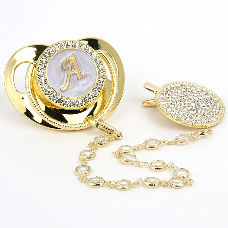 Personalized gold baby pacifier with letter A and crystal clip chain.