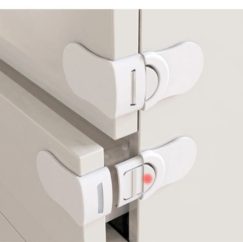 White baby safety drawer locks installed on cabinet and drawer corners for childproofing.