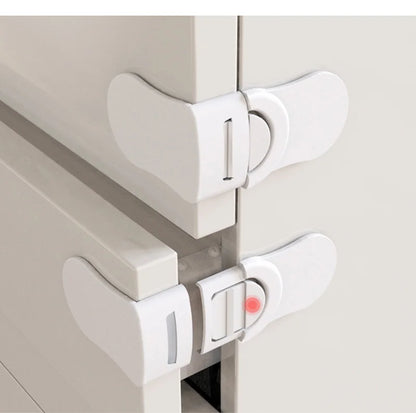 White baby safety drawer locks installed on cabinet and drawer corners for childproofing.
