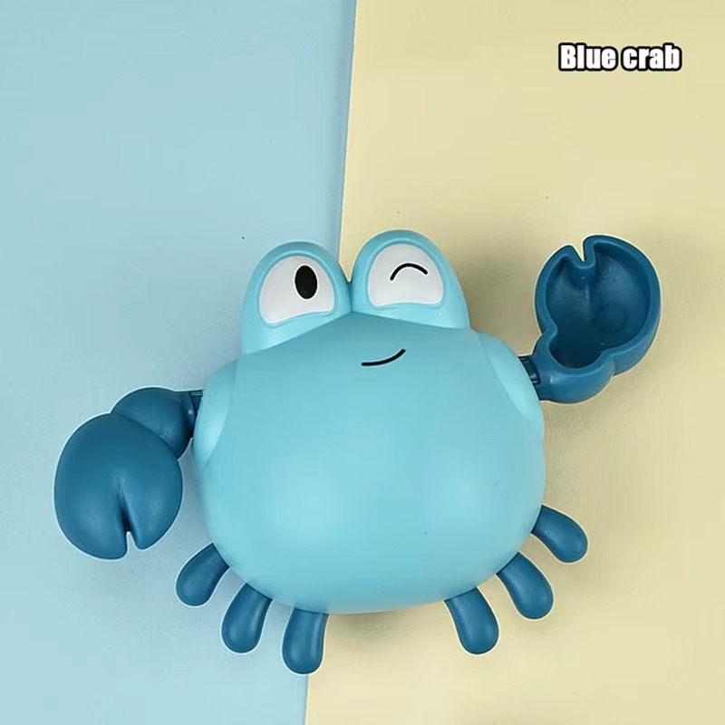 Baby Clockwork Bath Toy blue crab with raised claw and smiling face.