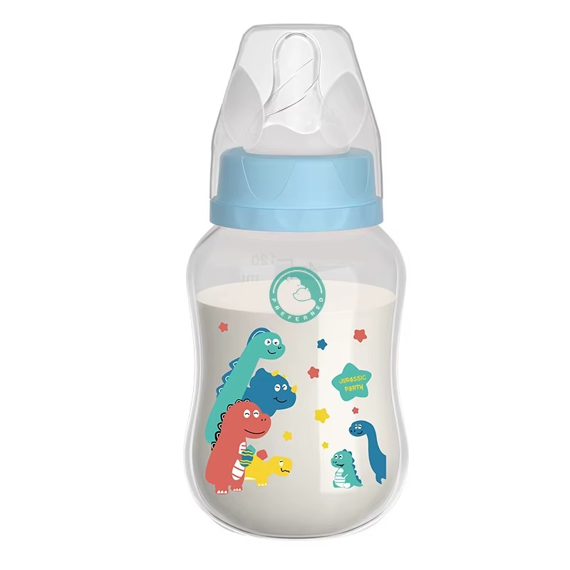 240ml BPA-free baby bottle with blue lid and dinosaur design, easy grip handles, filled with milk.