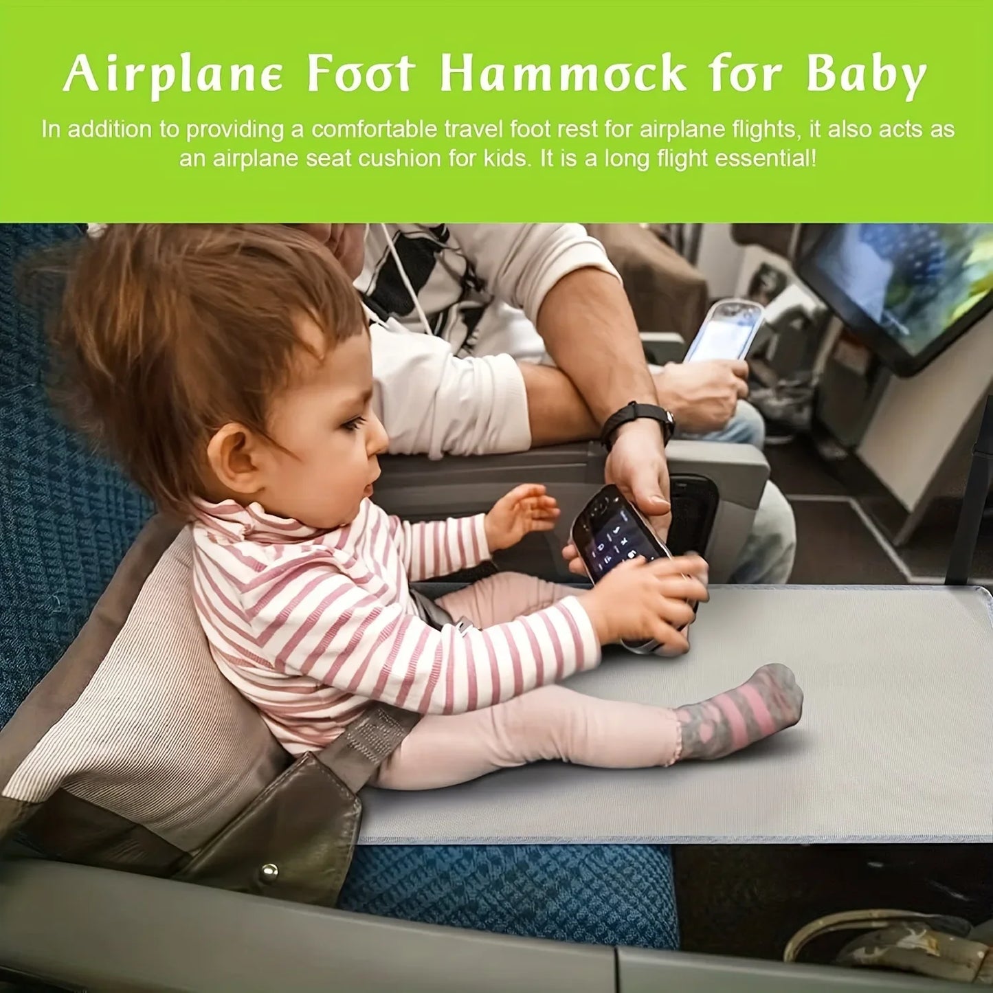 Baby seated on gray airplane foot hammock playing on airplane seat.