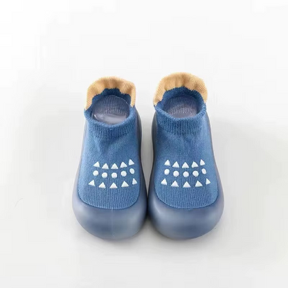 Blue breathable baby walking shoes with soft sole and white anti-slip pattern front view.