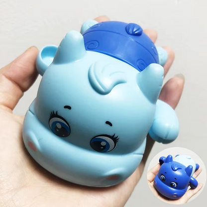 Blue calf wind-up bath toy held in hand showing face and body.