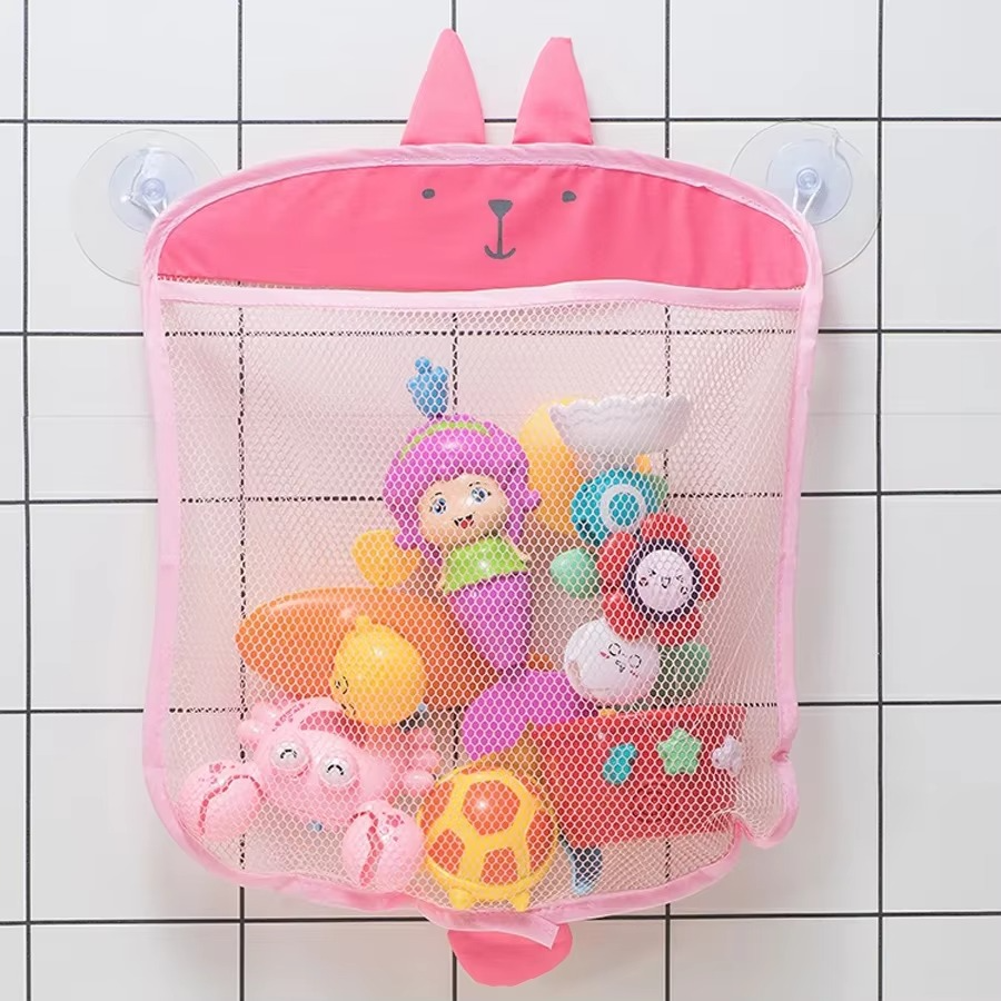 Pink bunny-themed baby bath toy storage mesh bag with suction cups filled with bath toys.