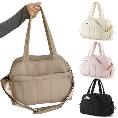 Beige waterproof diaper travel bag with long handles and shoulder strap, shown with color variants.