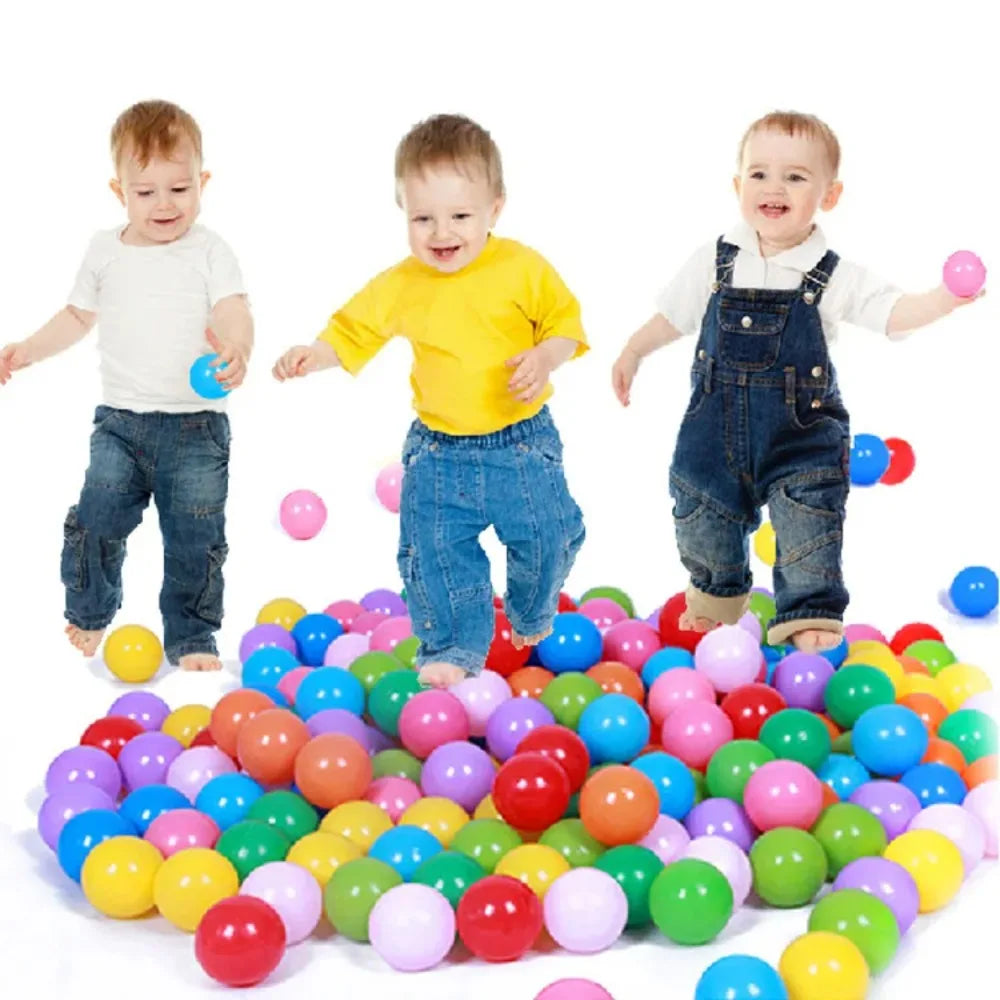 Toddlers playing in a large pile of colorful 100-piece play balls for ball pit fun.