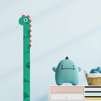 Green dinosaur growth chart decal on blue wall beside plush toy and basket on dresser.