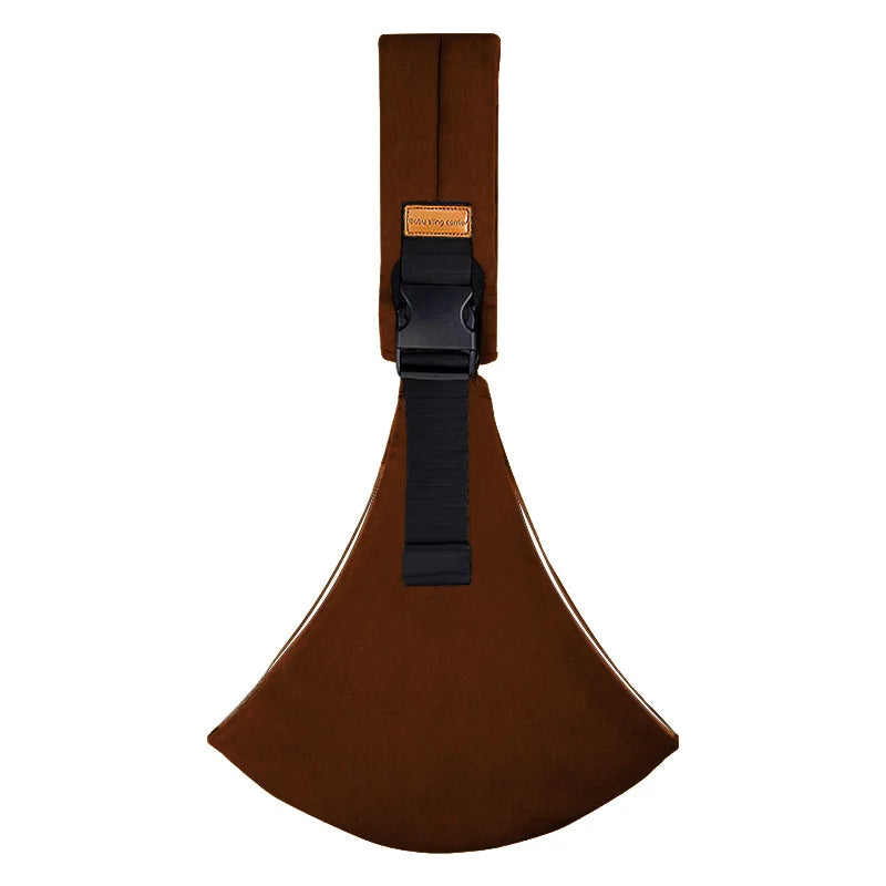 Brown adjustable baby carrier wrap with buckle and strap flat lay.