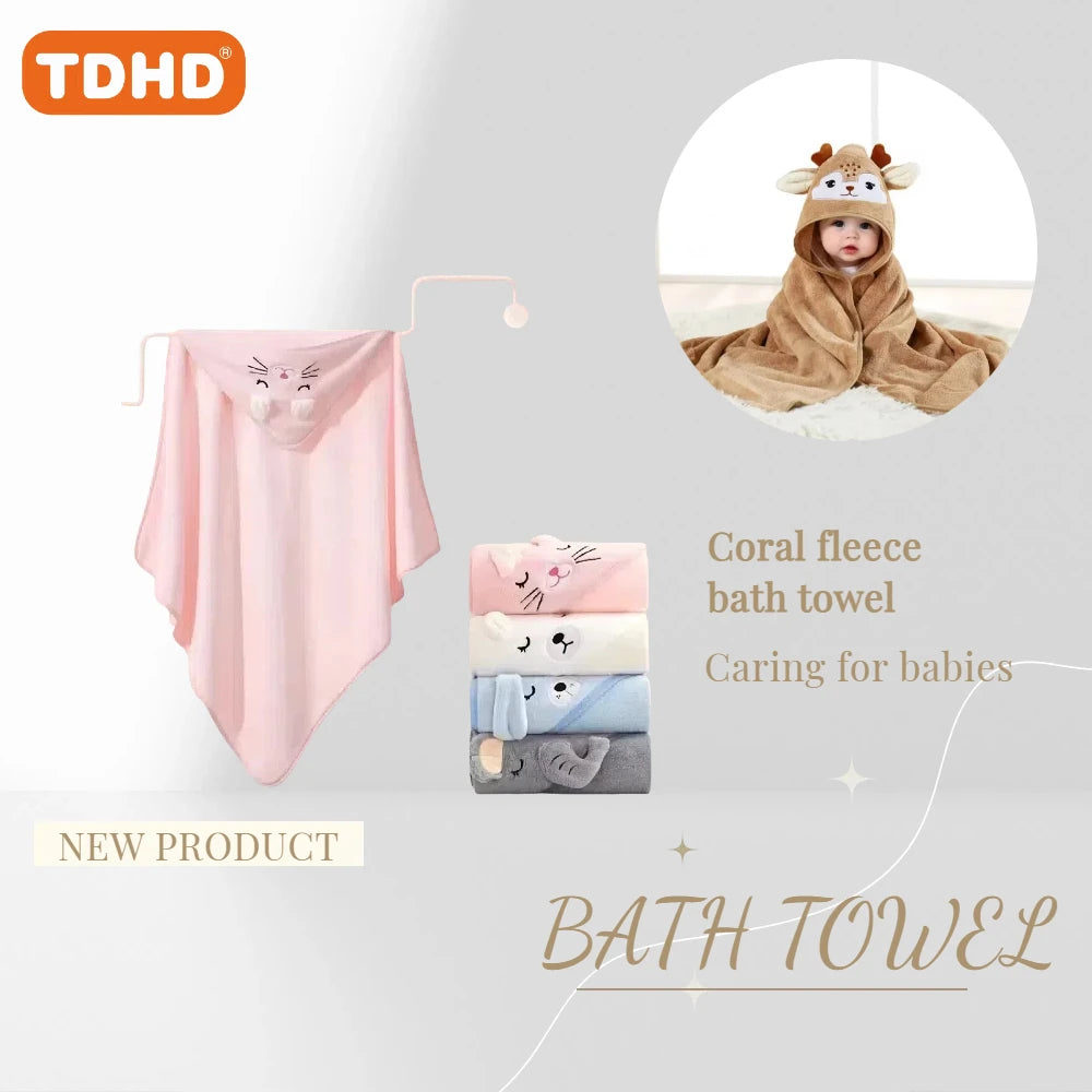 Folded pink animal hooded baby bath towel with embroidered face next to stack of assorted color towels.