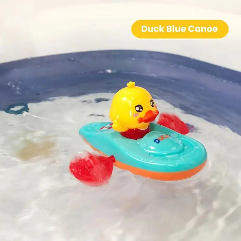 Blue canoe bath toy with yellow duck and red paddles floating in water.