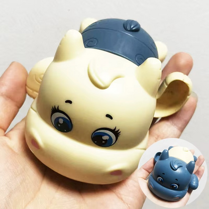 Lake blue calf wind-up bath toy held in hand showing face and body.