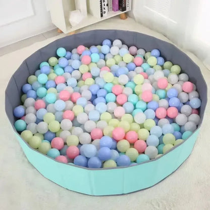 Round soft play pool filled with pastel-colored plastic balls from 100-piece colorful ball set.