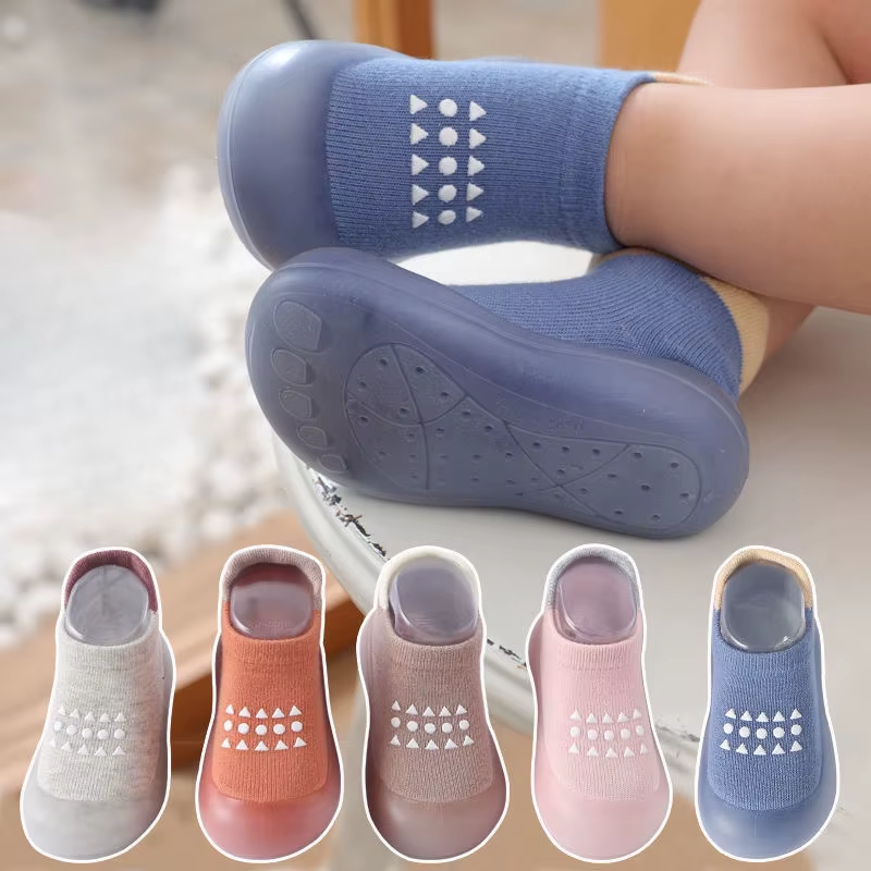 Close-up of baby feet in blue breathable soft sole walking shoes with five color options below.