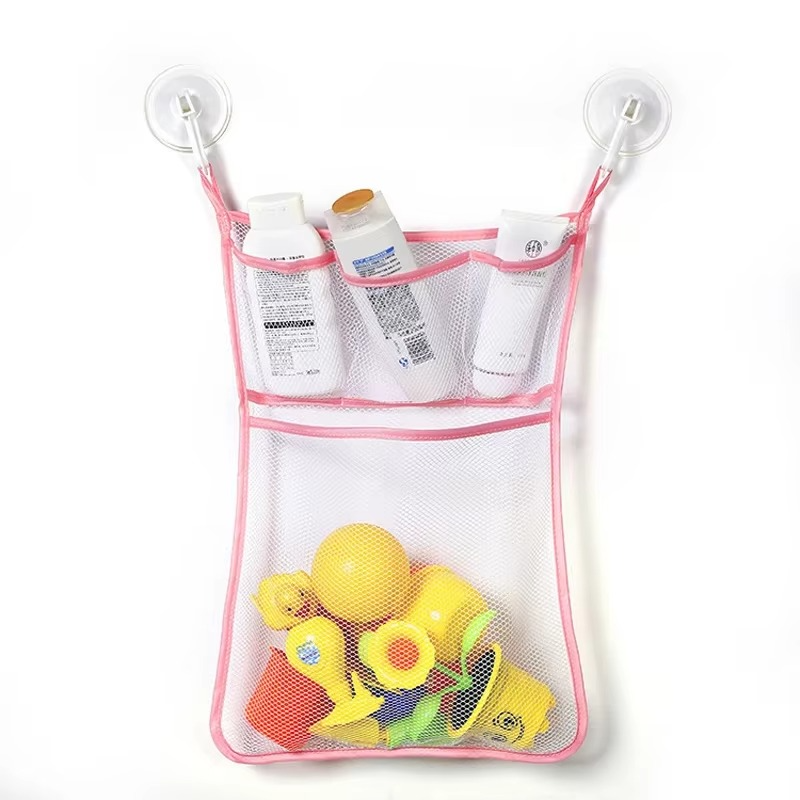Pink baby bath toy storage mesh bag with suction cups holding bottles and yellow bath toys.