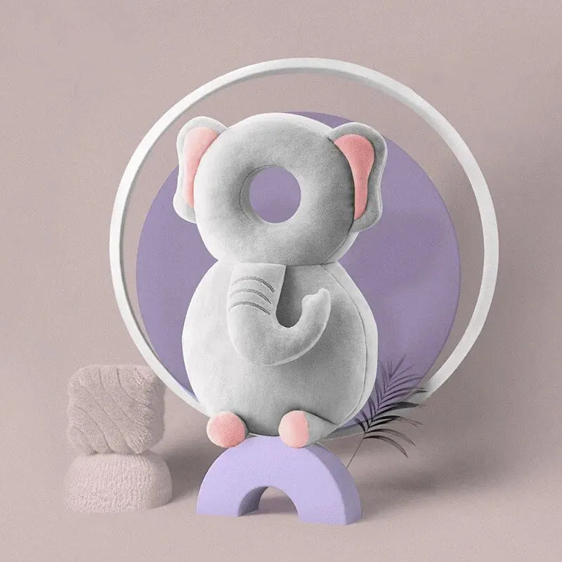 Soft elephant baby head protection pillow backpack with plush ears and trunk on purple background.