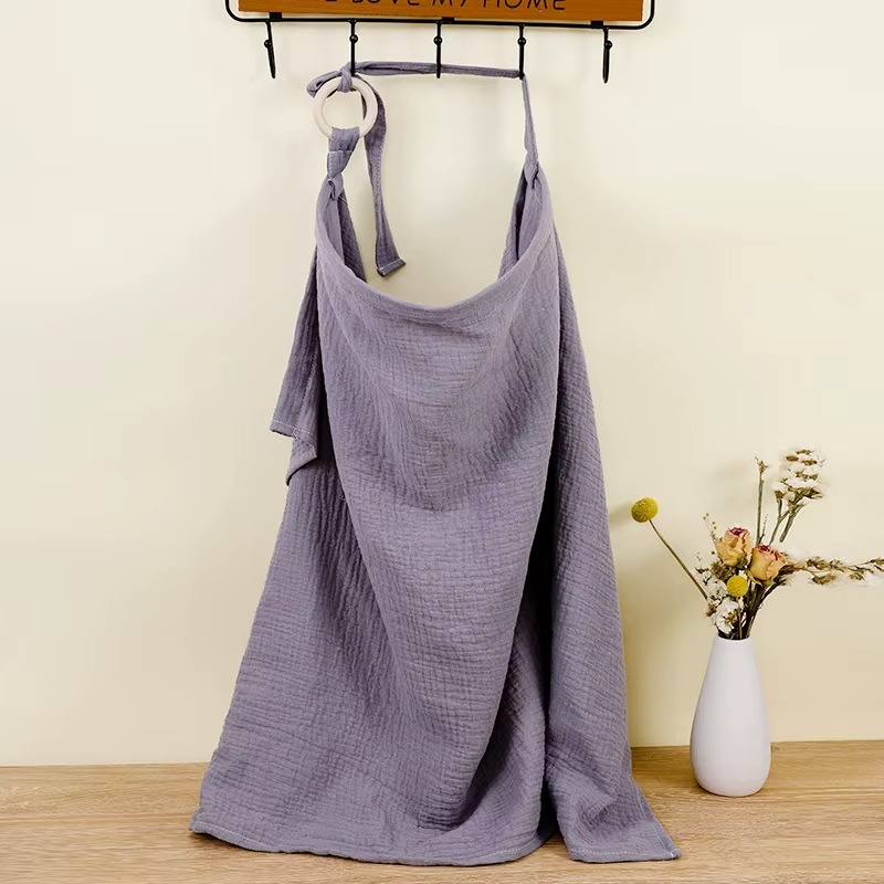 Gray blue breathable muslin nursing cover hanging with adjustable strap and ring detail.