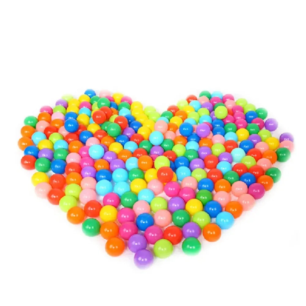 Heart shape arrangement of colorful plastic balls from 100-piece play ball set for kids.