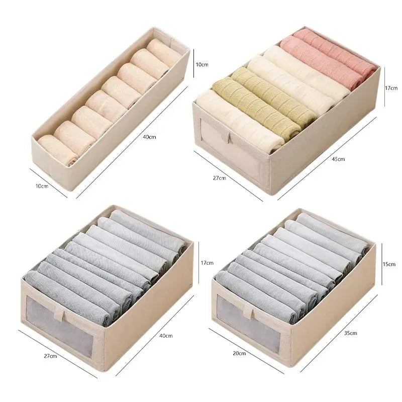 Beige foldable fabric storage boxes with clear-view fronts shown with dimensions, filled with rolled and folded baby clothes.