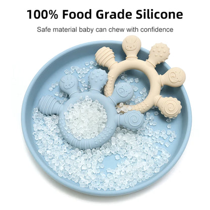 Blue and beige silicone baby teething rings displayed with food grade silicone pellets.