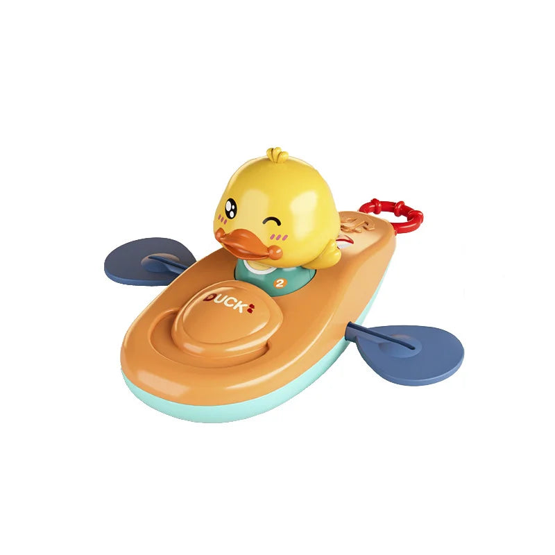 Yellow duck on orange kayak bath toy with blue paddles and red pull cord.