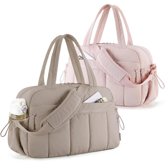 Waterproof diaper travel bags in beige and pink with shoulder straps and multiple exterior pockets.