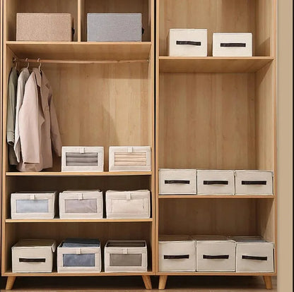 Wooden closets organized with beige and grey foldable fabric storage boxes with clear-view fronts and handles.
