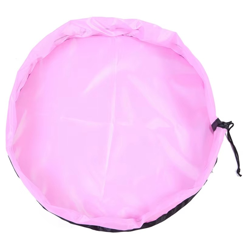 Pink foldable portable toy storage play mat bag with drawstring closure laid flat.