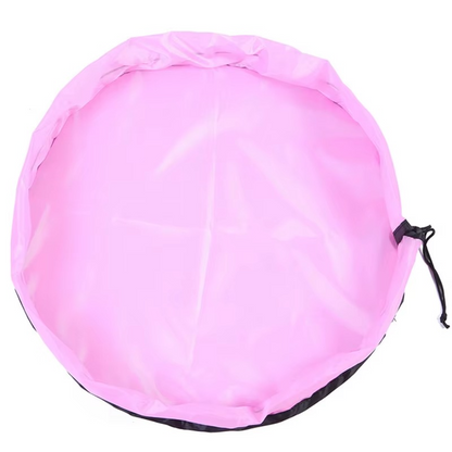 Pink foldable portable toy storage play mat bag with drawstring closure laid flat.