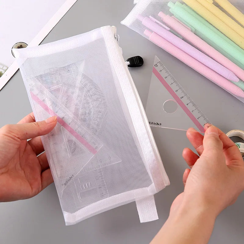 Medium mesh zipper bag with stationery items including ruler being organized on desk.