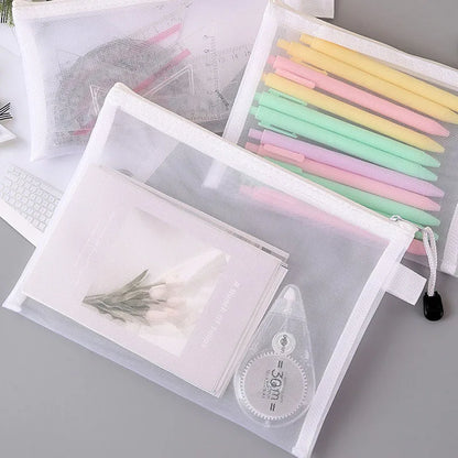 Three mesh zipper bags with pens, papers, and correction tape for organized storage.