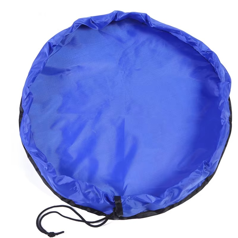 Blue foldable portable toy storage play mat bag with drawstring closure laid flat.