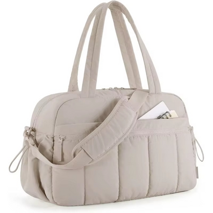 Camel waterproof diaper travel bag with shoulder strap and front zippered pocket.