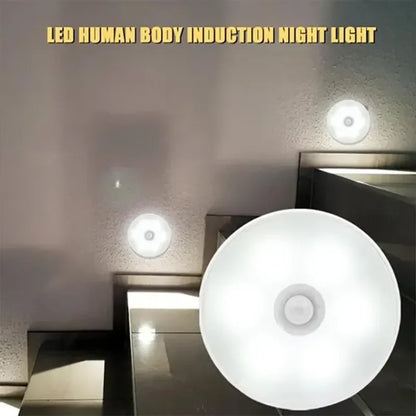 Multiple LED motion sensor night lights installed on stairway walls emitting white light.