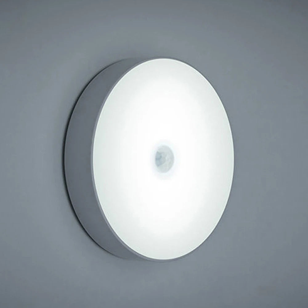 Rechargeable white motion sensor night light mounted on wall, no switch, soft LED glow.