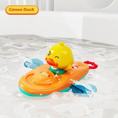 Yellow duck kayak bath toy floating in water with moving blue paddles.