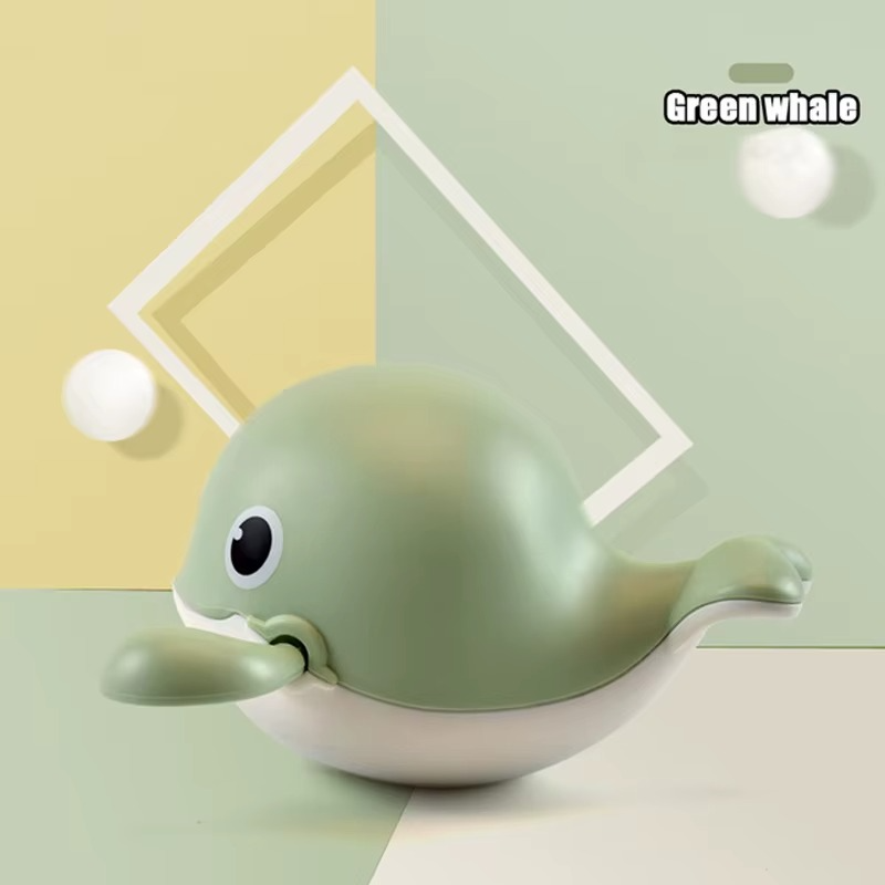Green whale wind-up bath toy on green geometric background.