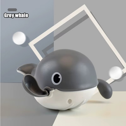 Grey whale wind-up bath toy on grey geometric background.