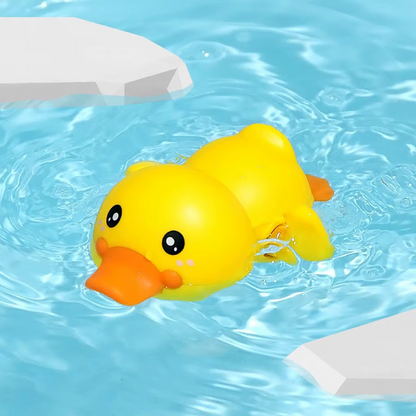 Baby Clockwork Bath Toy yellow duck swimming in water with orange beak.