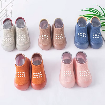 Variety of breathable baby walking shoes in multiple colors with soft soles and anti-slip patterns, arranged in rows.
