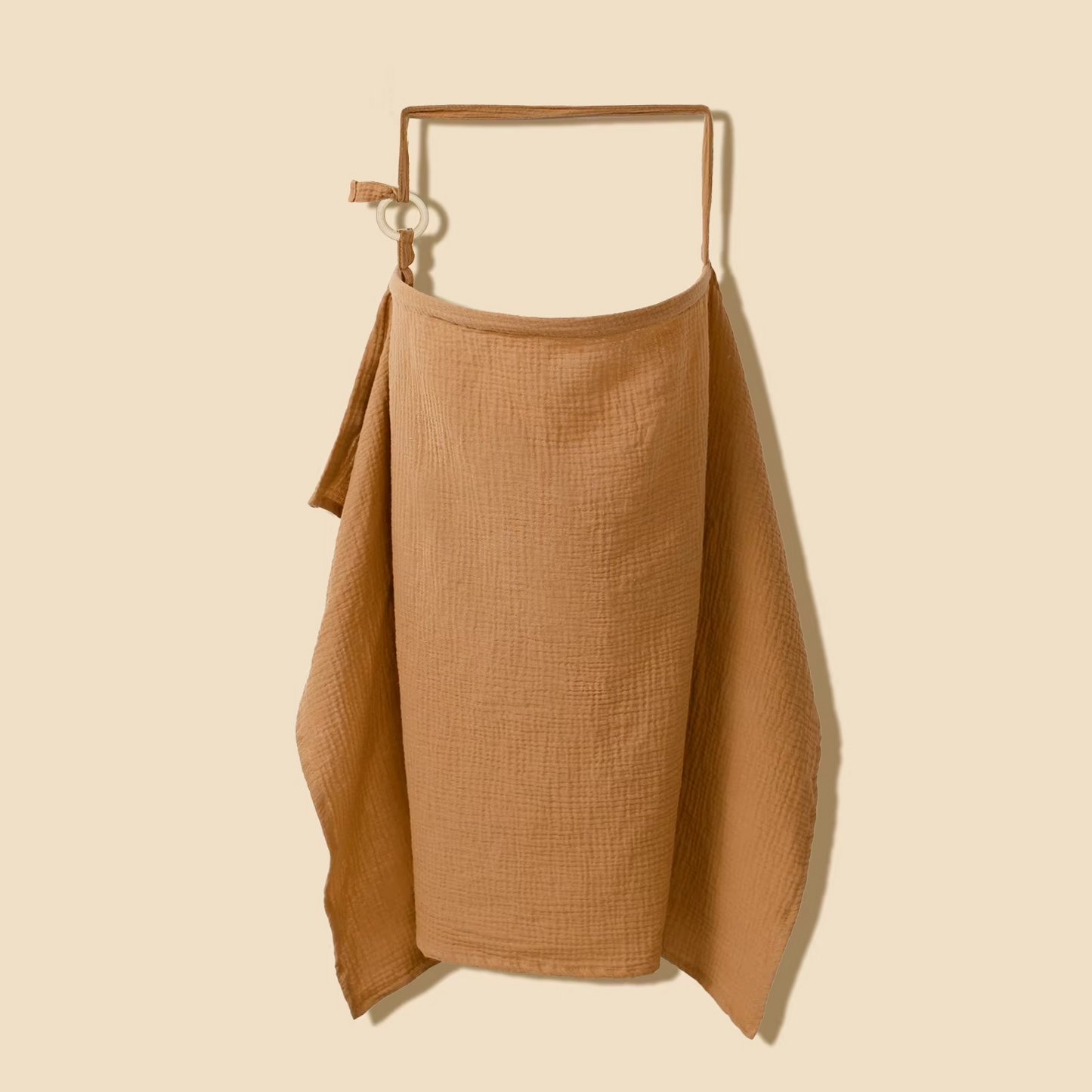 Chocolate breathable muslin nursing cover hanging with wooden ring adjustable strap.