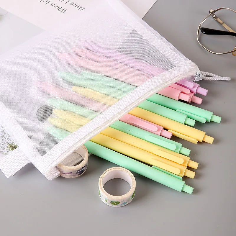 Medium mesh zipper bag with pastel pens spilling out on desk for pen storage.