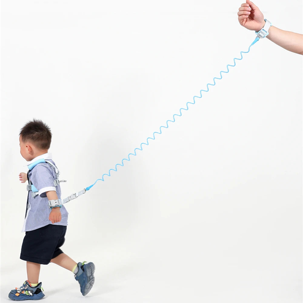 Toddler wearing blue anti-lost safety harness with 2m spring leash wrist strap in use.